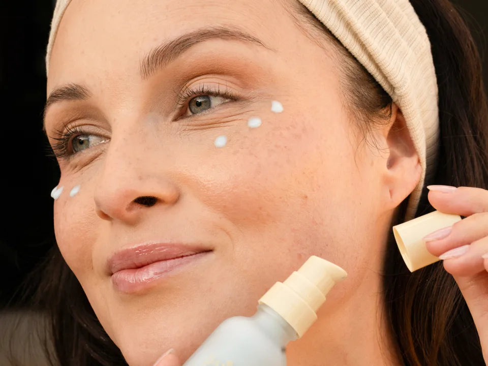 Close-up of a person dotting Blue Algae Firming Serum under the eyes and along the cheek