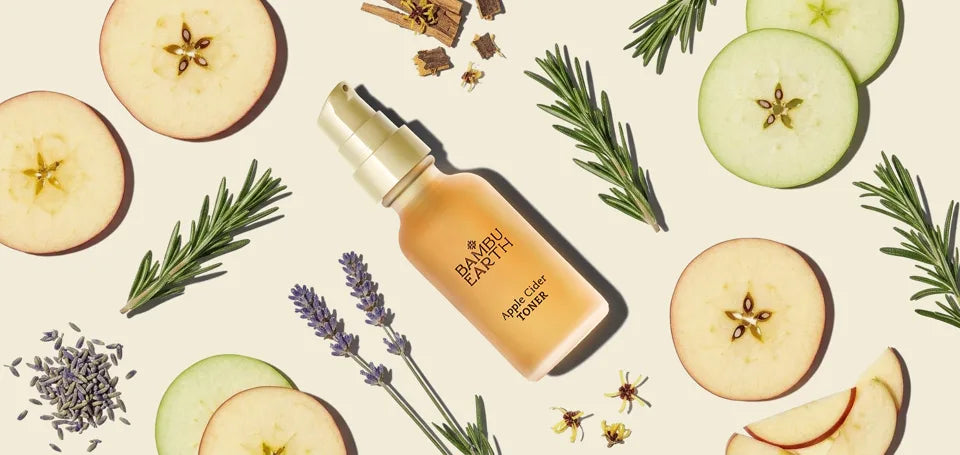 Apple Cider Toner bottle with apple slices, rosemary, lavender, and witch hazel