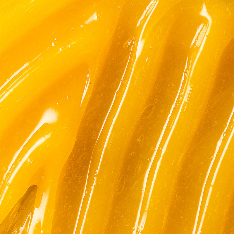 Macro of the golden Renewing Gel spread and catching the light.