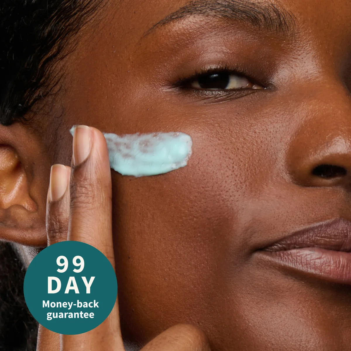 Close-up of the serum being smoothed onto a cheek, with a 99-day money-back guarantee seal