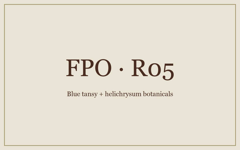 FPO: blue tansy and helichrysum flowers laid out on linen.