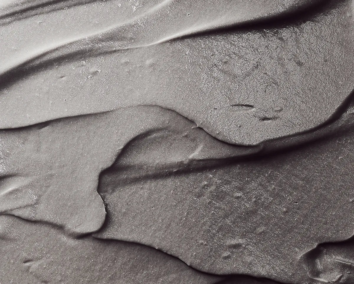 Close-up of the pale-gray French Clay Refining Cleanser cream texture