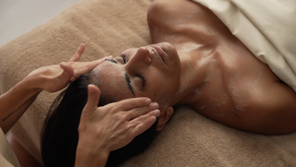 Cream cleanser being massaged onto damp skin