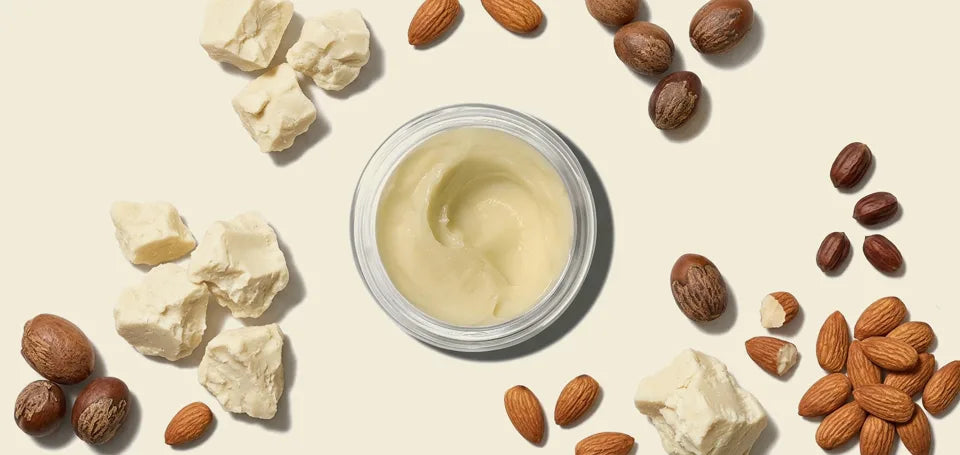 Shea Butter Moisturizer in an open jar with raw shea butter, jojoba, and almonds