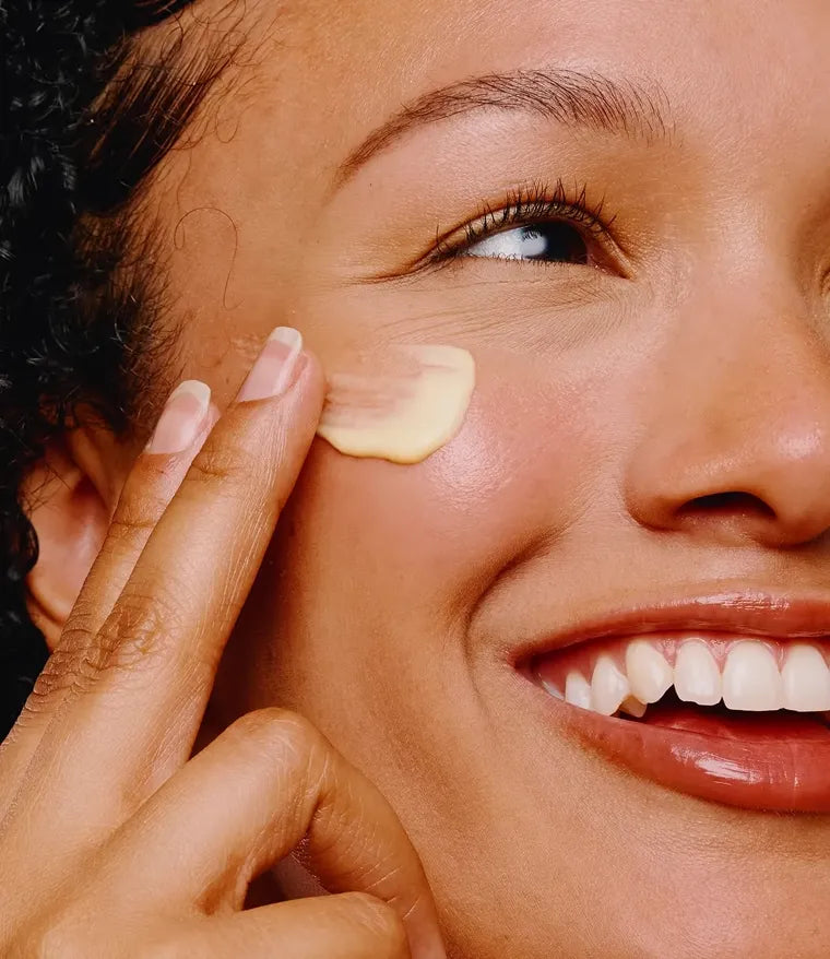Woman applying Bambu Earth moisturizer to her cheek