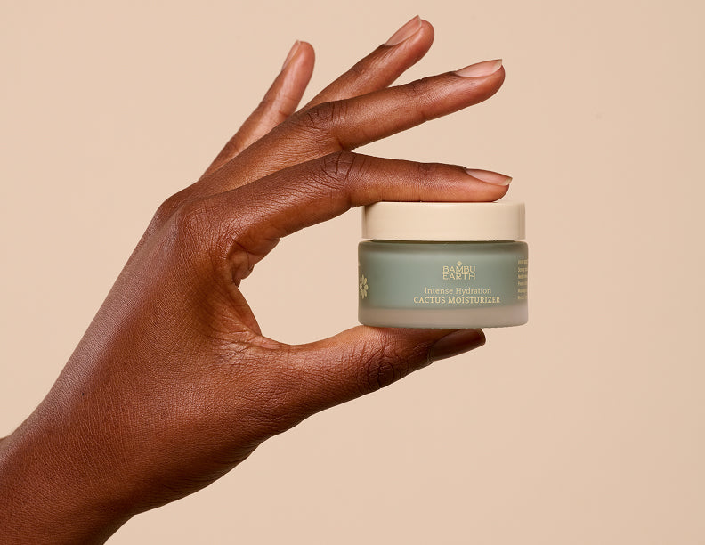Hand holding the closed Cactus Moisturizer jar