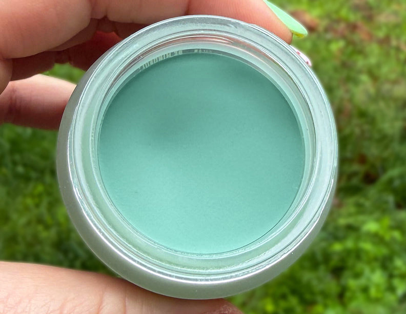 Open jar held in hand showing a smooth, restored surface